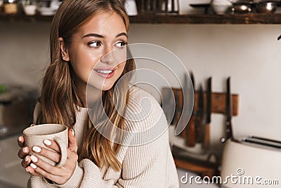 Image of beautiful nice woman drinking coffee and looking aside Stock Photo