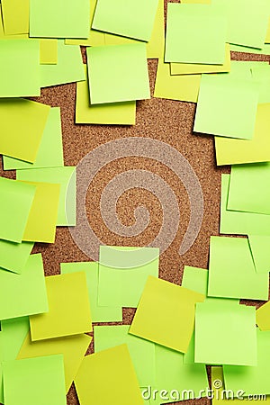 Image of blank green and yellow sticky notes on cork bulletin bo Stock Photo
