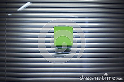 Image of blank sticky note on office glass wall with jalousie Stock Photo