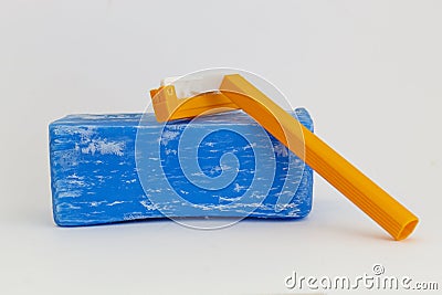 Blue Washing Soap and Orange Shaving Razor on Gray Background Stock Photo