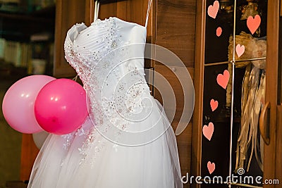 Image of the bodice of a weeding dress on a hanger Stock Photo