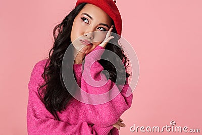 Image of bored beautiful asian girl wearing beret looking at copyspace Stock Photo