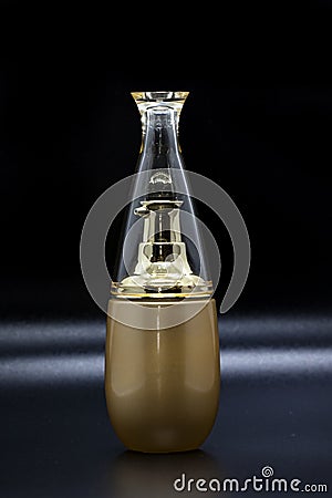 Image of a bottle of golden perfume. Stock Photo
