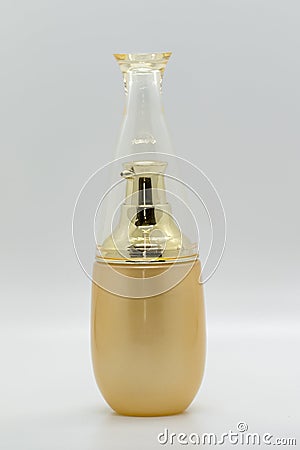 Image of a bottle of golden perfume. Stock Photo