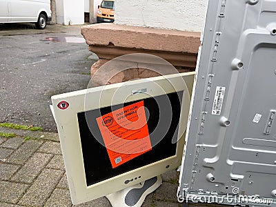 An image of a broken computer monitor on a standabandoned on a s Editorial Stock Photo
