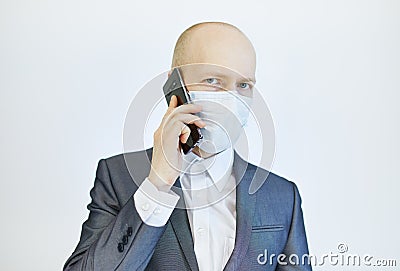 Image of business man wearing anti bacterial mask against virus and pollution with smartphone in hand Stock Photo