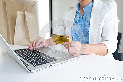 Image of business woman office leader holding credit card and using laptop for online shopping Stock Photo