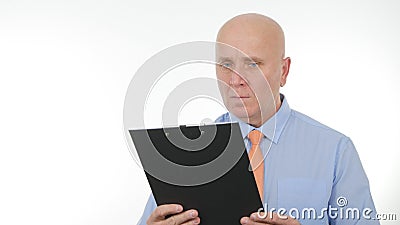 Businessperson Read and Compare Documents from a Clipboard Stock Photo