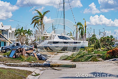 Image of a catamaran resting on a residential neighborhood street after Hurricane Ian Fort Myers FL Editorial Stock Photo