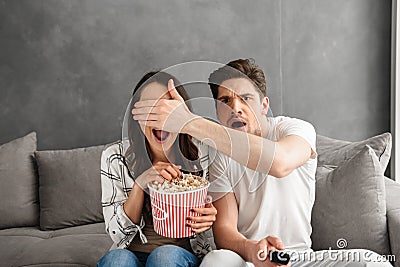 Image of caucasian uptight family sitting on sofa at home with p Stock Photo