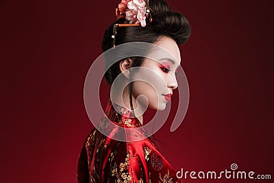 Image of charming geisha woman in japanese kimono looking downward Stock Photo