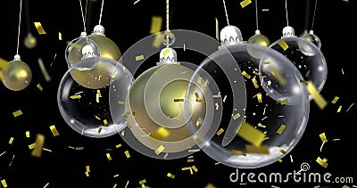 Image of christmas baubles dangling over confetti falling on black background Stock Photo