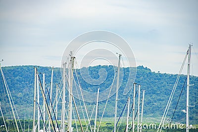 Image close up of boat pole in Marina with docked yachts and moored boats in calm blue sky Stock Photo