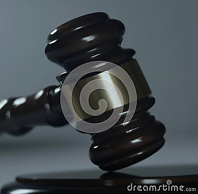 Image of close up of judge slamming gavel on grey background Stock Photo