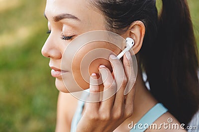 Image closeup of beautiful joyful woman 20s in sportswear using Stock Photo