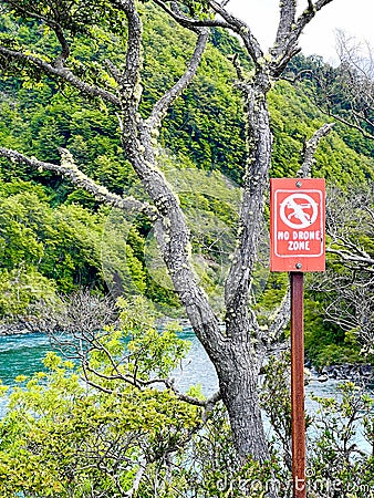 Image of a colourful No-fly zone sign - drone fly forbidden - sign in National Park among nature and trees Stock Photo