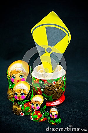 Concept Image With an Opened Matrioska In Which There Is The Symbol Of The Nuclear On Black Background Stock Photo