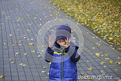 Image of cute baby boy with hat on his eyes, closeup portrait of adorable child, sweet toddler with blue eyes, healthy Stock Photo