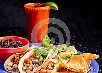 Image of a delicious red beverage with a taco plate Stock Photo