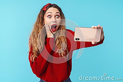 Image of delighted nice woman expressing surprise and using cellphone Stock Photo