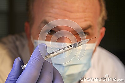 Image is depicting a medical Professional Preparing to give an ejection of the Corona Virus Vaccine. Stock Photo