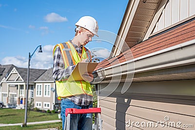 Home inspector providing an inspection to a house. Stock Photo