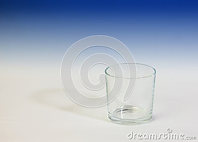 Image of empty glass with white background that fades into blue upwards. Stock Photo