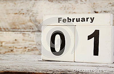 Image of February First wooden vintage calendar on white background Stock Photo