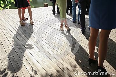 Image of feet of young people standing outdoor. Mixed race friends standing Stock Photo