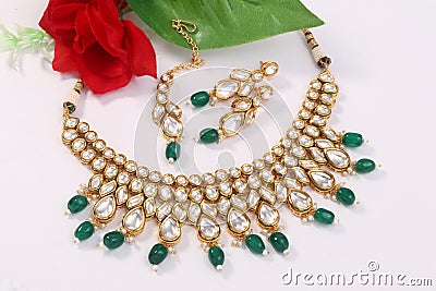 A image of a female jewelry chain with stones.For girls and women matching earrings, mangtika and necklace. Stock Photo