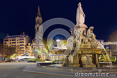 Image of Fontaine Pradier in Nimes at night illuminated Editorial Stock Photo