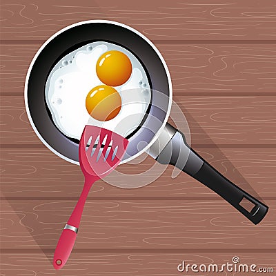 Image of fried eggs in a frying pan and cooking spatula Stock Photo