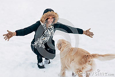 Image of girl hugging labrador in winter park for walk Stock Photo