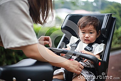 A girl who hates child seats for bicycles Stock Photo