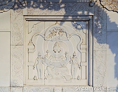 Image of the god Ganesh with his two wives and Shiva with Parvati on the wall of public hindu temple Lakshmi Narayana Stock Photo
