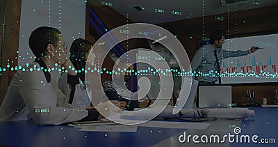 Image of graphs with changing numbers, diverse manager explaining reports on screen in office Stock Photo