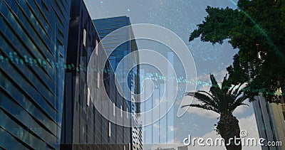 Image graphs, globe and changing numbers over low angle view of trees and modern buildings Stock Photo