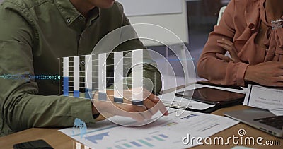 Image of graphs, globe, computer language over diverse colleagues analyzing report in office Stock Photo