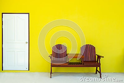 An image of a green room with white door and double chair wooden. Stock Photo