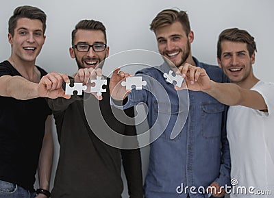 Image of the guys connecting pieces of the puzzle Stock Photo