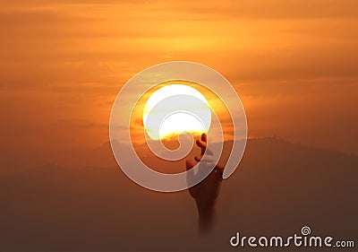 Image of a hand reaching up to the sun. Stock Photo