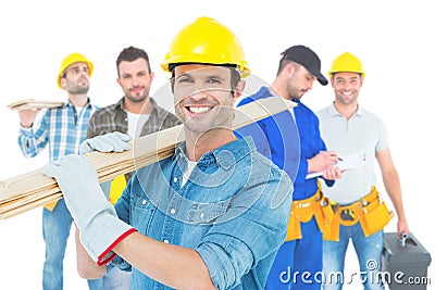 Image of happy carpenter carrying wooden planks Stock Photo