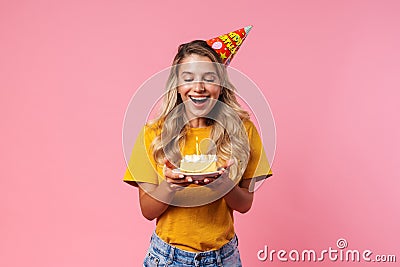 Cheery birthday woman holding cake with candle Stock Photo