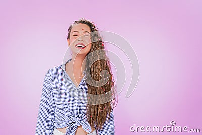 Image of a happy young excited lovely curly woman posing copy space isolated over purple wall background. A girl smiling Stock Photo