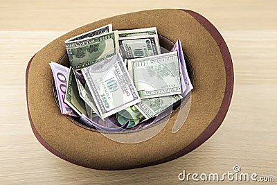 Image of hat money wooden desk Stock Photo