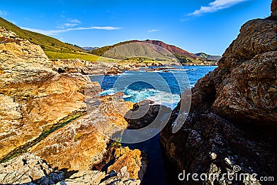 Hidden tide pool nook on west coastline with cliffs and ocean Stock Photo