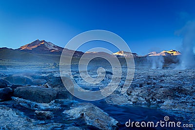 Image of hot steams and smoke columns. Taken during sunrise at Geysers of Tatio at Los Flamencos national reserve in Atacama Stock Photo