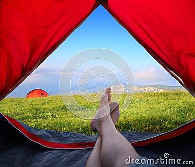 Image human legs lying in tourist tent Stock Photo