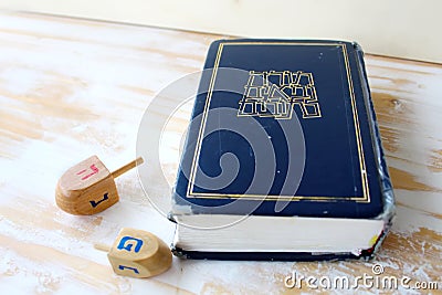 Image of Jewish holiday Hanukkah. Hebrew Bible Tanakh Torah, Neviim, Ketuvim and Wooden dreidels toys Hanukkah, holiday symbols Stock Photo