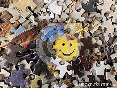 The image of a joyful face on cardboard. Puzzle in detail in a mosaic set. Concept: joy, happiness, positive, kindness Stock Photo